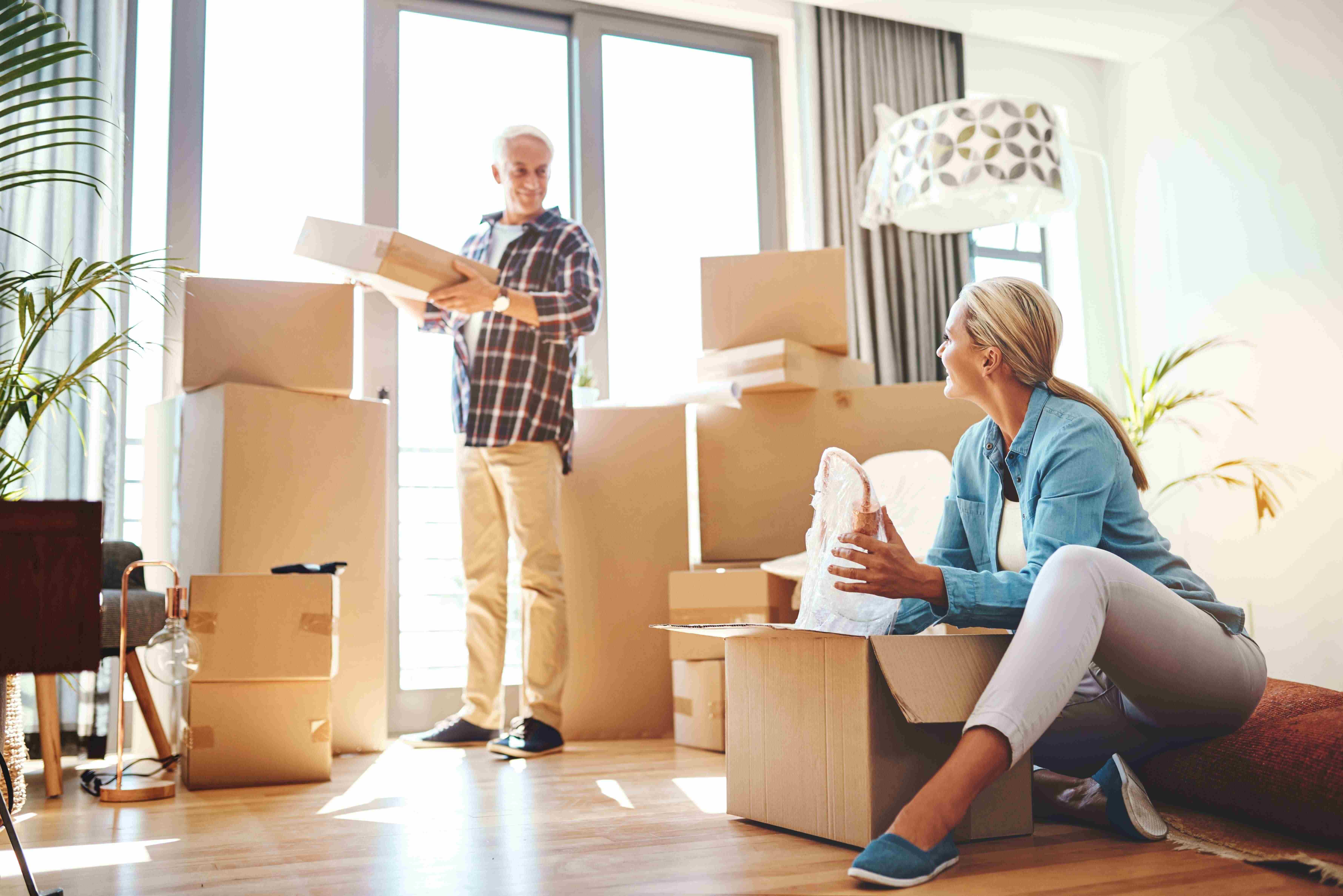 Couple unpacking boxes after moving into their new Park Bungalow at Regency Living